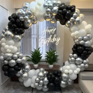 Black, silver and white circular balloon ring birthday decoration with Happy Birthday neon sign in Indore