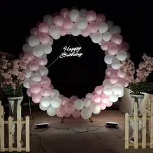 Birthday balloon decoration with pink and white circular balloon ring and night lighting in Indore
