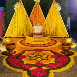 Boho haldi outdoor decoration with macrame dreamcatcher drapes wildflowers and low seating in Indore