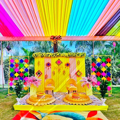 Carnival kids birthday party decoration with colorful balloon arch character cutouts and game zone in Indore