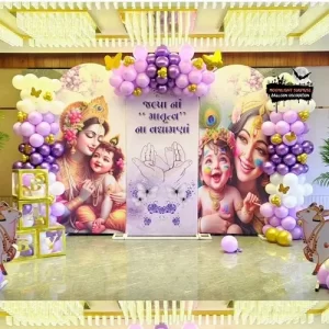 Krishna theme naming ceremony balloon decoration with purple gold arch and Yashoda Krishna backdrop in Indore