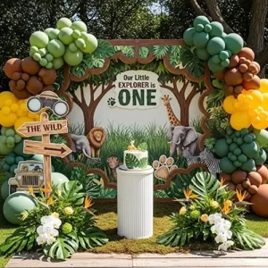 Little Explorer safari first birthday outdoor theme with green brown balloon arch and animal backdrop Indore