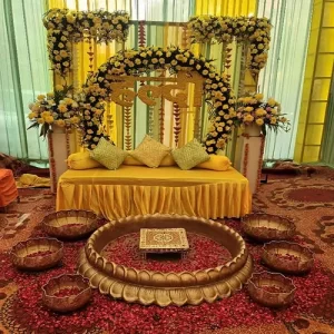 Modern minimalist haldi setup with clean white backdrop geometric props and selective floral accents in Indore