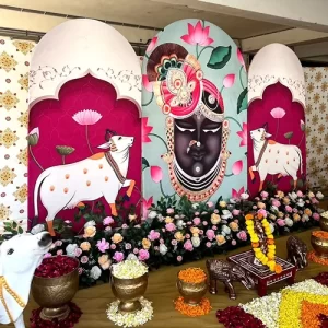 Naming ceremony Shrinathji floral decoration with cow panels and brass vessel arrangements in Indore