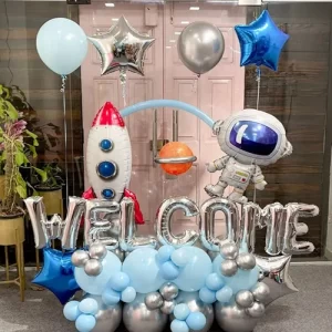 Space theme welcome baby balloon decoration with rocket astronaut foil balloons and silver letters in Indore