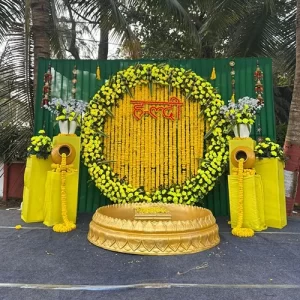 White yellow haldi ceremony decoration with floral backdrop white drapes and traditional ritual props in Indore